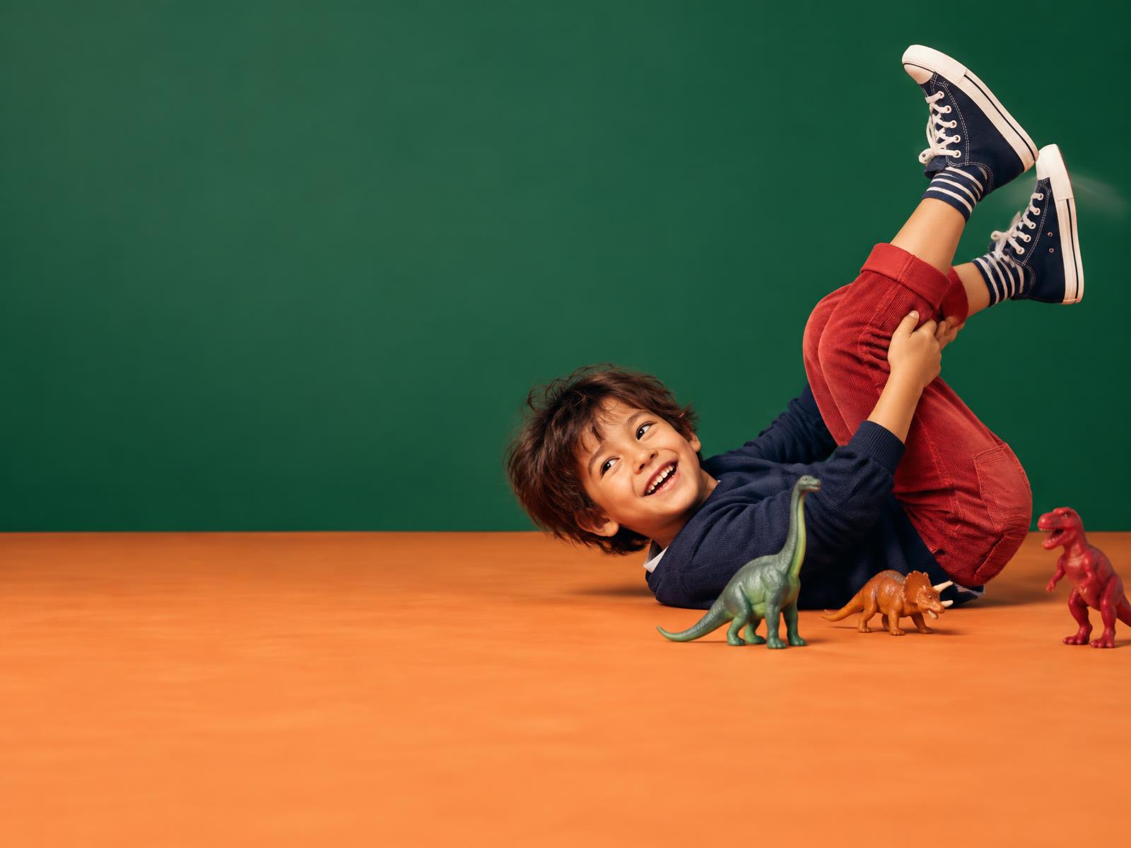 A child playing imaginatively with dinosaur toys